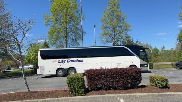 Our Motorcoach awaits our sightseeing group